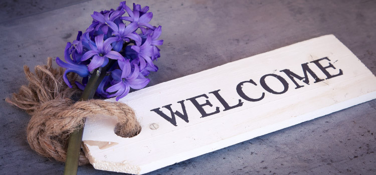 wooden welcome sign tied to hyacinth