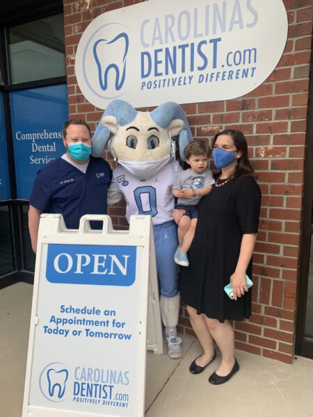 Dr. Zukerman and his family were face masks while posing with Rameses the UNC mascot outside CarolinasDentist in Chapel Hill, NC