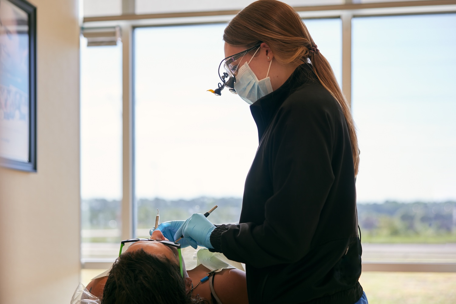 hygienist performing six-month dental checkup at CarolinasDentist