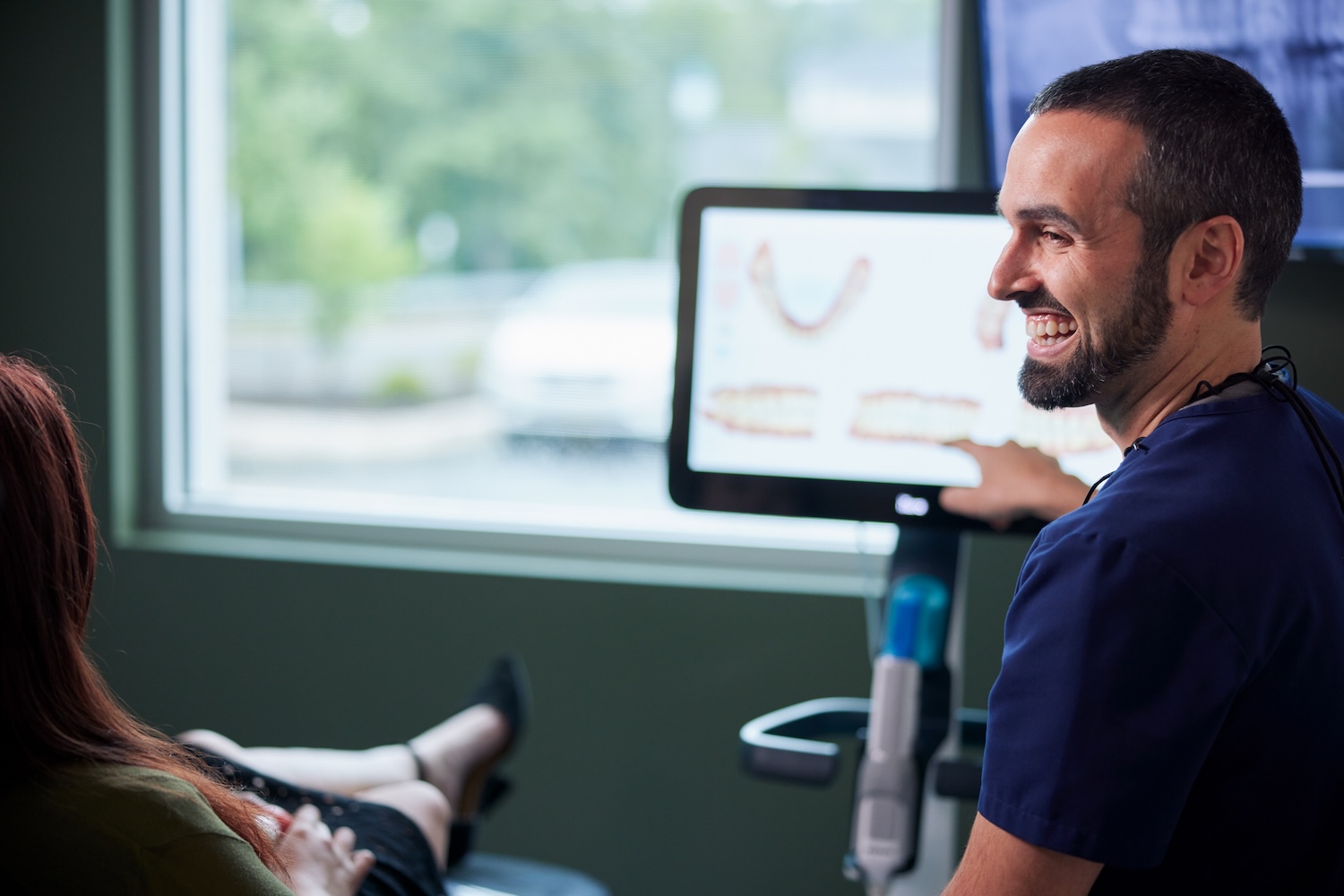 dentist Dr. Sean Dekow at CarolinasDentist discussing dental implants or other restorative treatment with patient