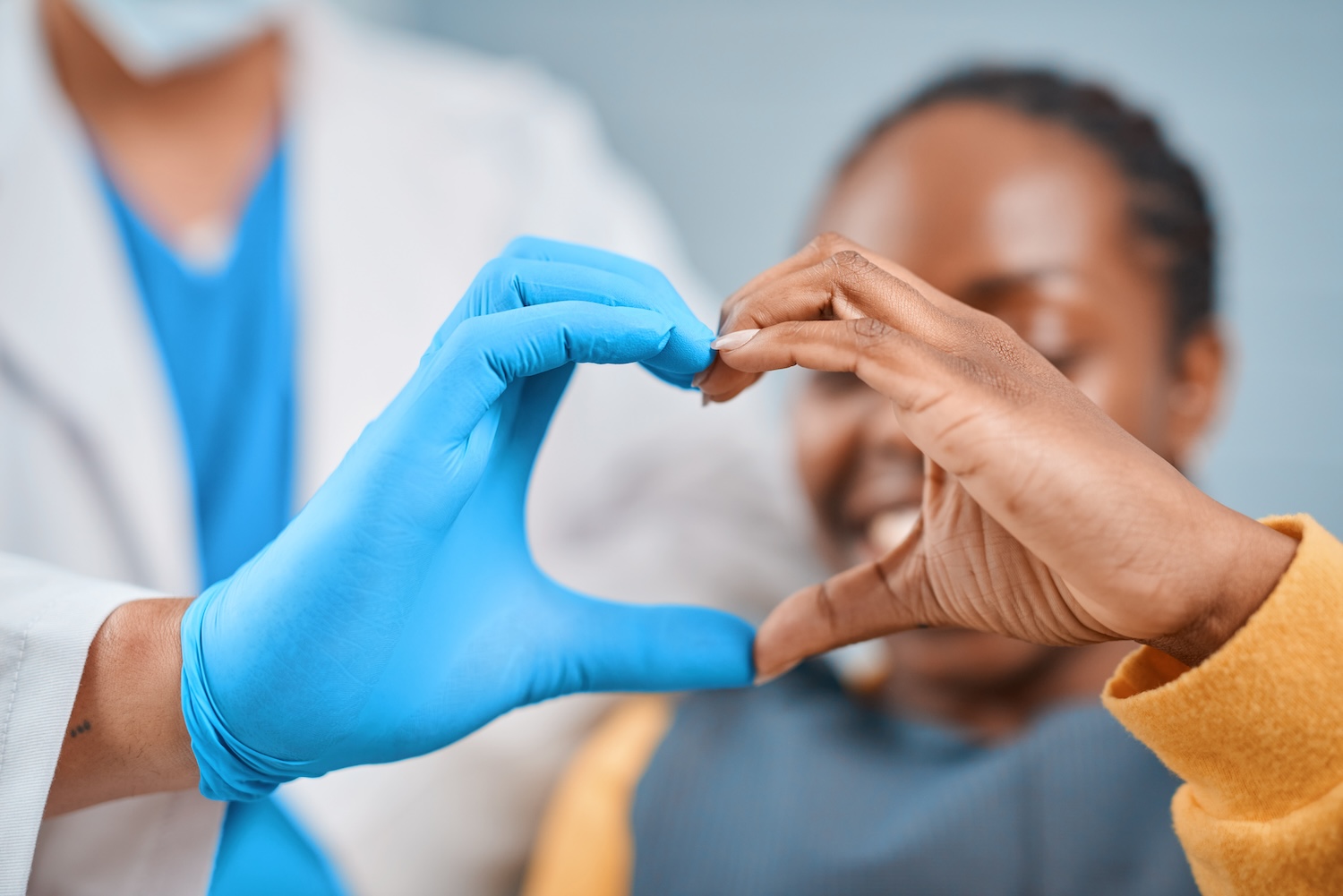 dentist and patient hands forming a heart, inclusion in dentistry, dental diversity