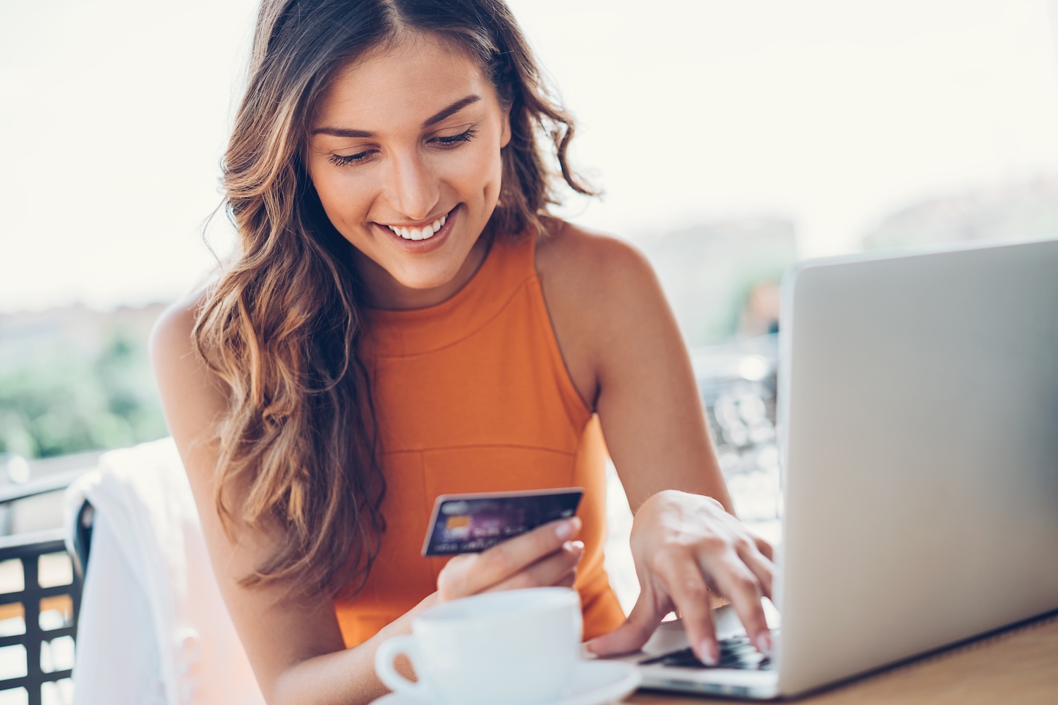woman paying bills after dental discount plan