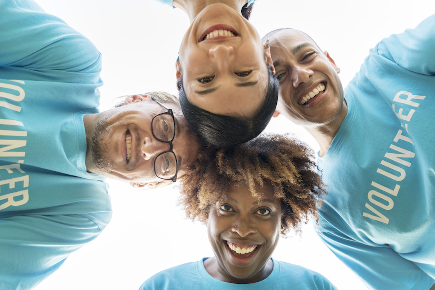 Photograph of happy and diverse volunteers involved in community. CarolinasDentist, community involvement, volunteer