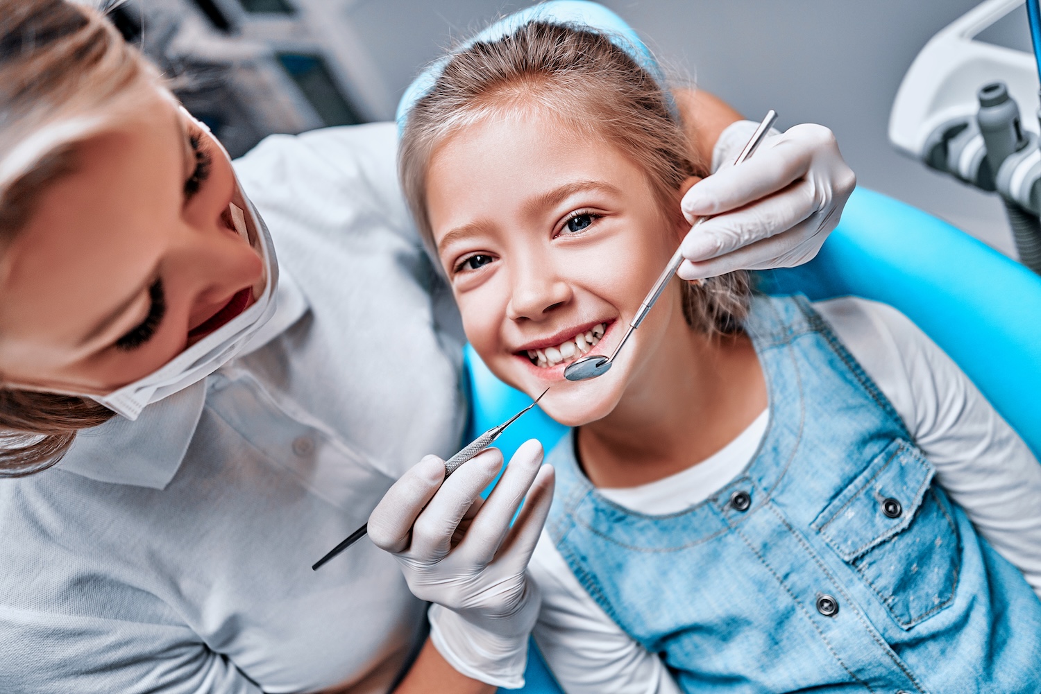 child in dental chair to maintain a good summer dental routine to help with kids brushing