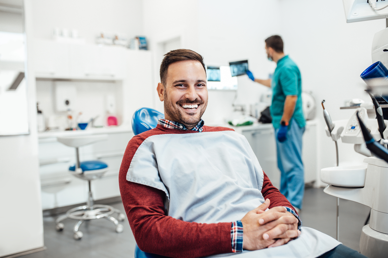 new year's resolutions, smile resolutions, Young good looking man having dental treatment at dentist's office.